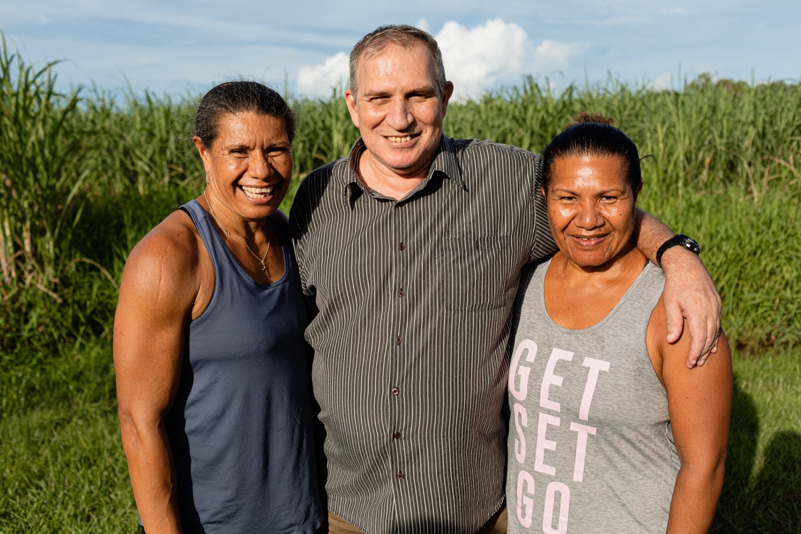 An i'ara participant with his family in front of the sugar cane near their Far North Queensland home
